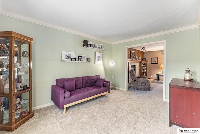 carpeted living area featuring baseboards and ornamental molding