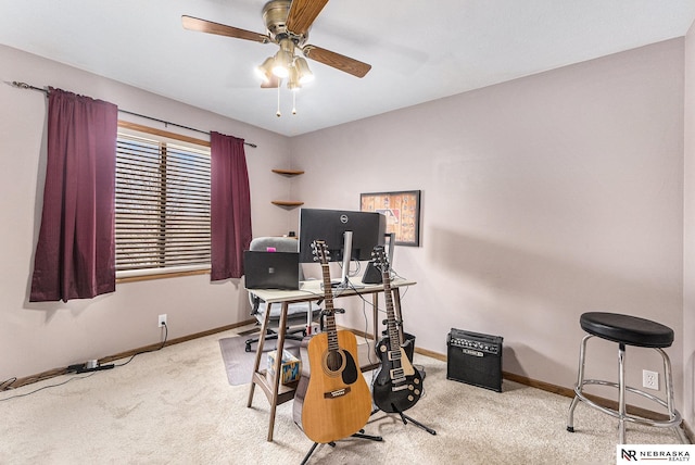 carpeted home office with ceiling fan and baseboards