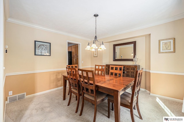 dining room with visible vents, crown molding, light carpet, baseboards, and a chandelier