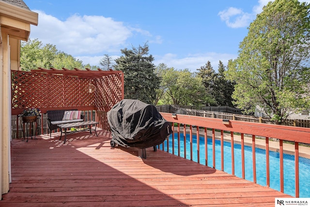 wooden terrace featuring a fenced in pool and a fenced backyard