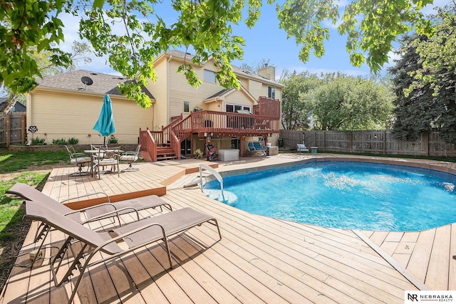 view of pool featuring a fenced in pool, a fenced backyard, stairs, and a deck