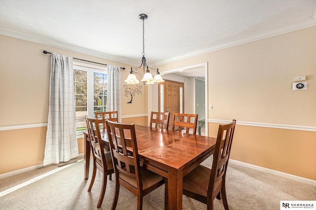 dining area with baseboards, ornamental molding, a notable chandelier, and light carpet