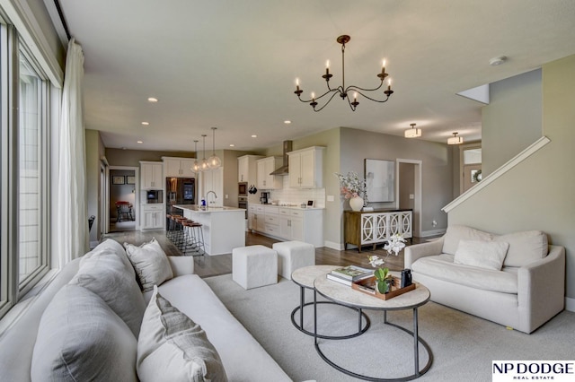 living room with recessed lighting, baseboards, and a notable chandelier