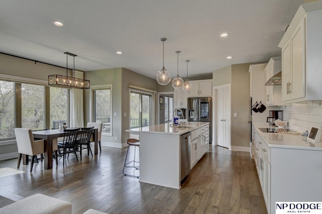 kitchen with exhaust hood, recessed lighting, and light countertops