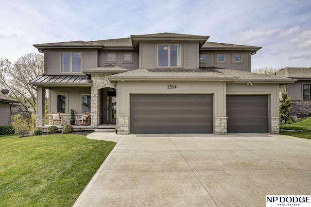 prairie-style home with a front lawn, covered porch, stone siding, an attached garage, and driveway