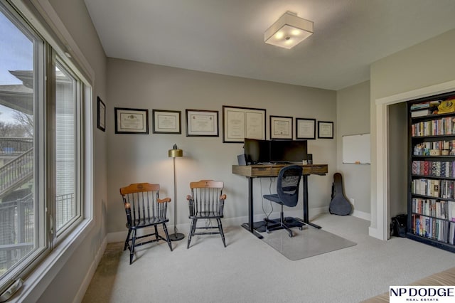 carpeted home office with baseboards