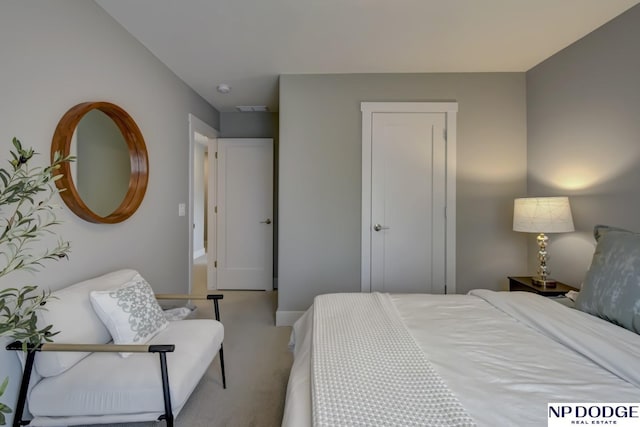 carpeted bedroom featuring baseboards