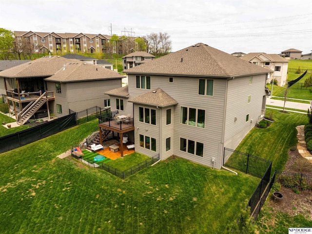 rear view of property with a deck, a fenced backyard, stairs, a lawn, and a residential view