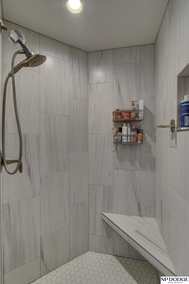 bathroom featuring a tile shower