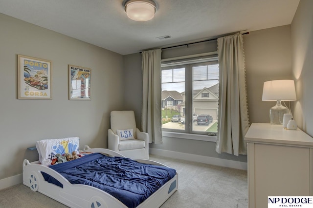 bedroom featuring baseboards, visible vents, and light carpet