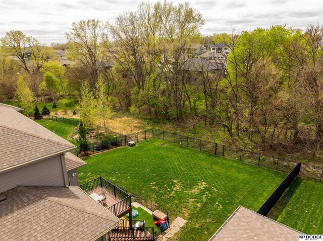 view of yard featuring fence and a wooden deck