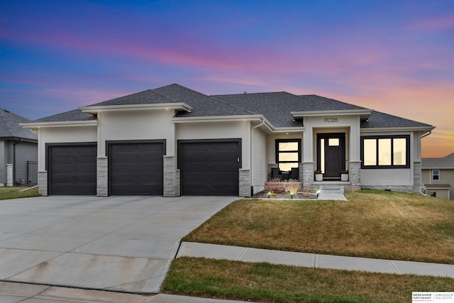 17026 Emma St, Bennington, NE 68007 - prairie-style house with stucco siding, a shingled roof, concrete driveway, an attached garage, and a yard