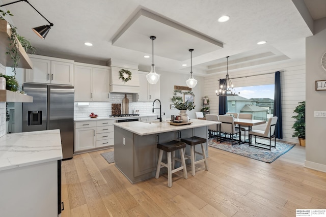 17026 Emma St, Bennington, NE 68007 - kitchen featuring white cabinets, appliances with stainless steel finishes, backsplash, and a tray ceiling