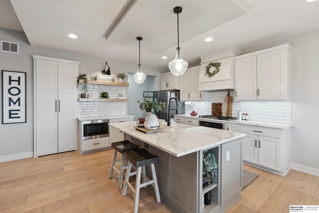 17026 Emma St, Bennington, NE 68007 - kitchen with open shelves, appliances with stainless steel finishes, premium range hood, baseboards, and visible vents