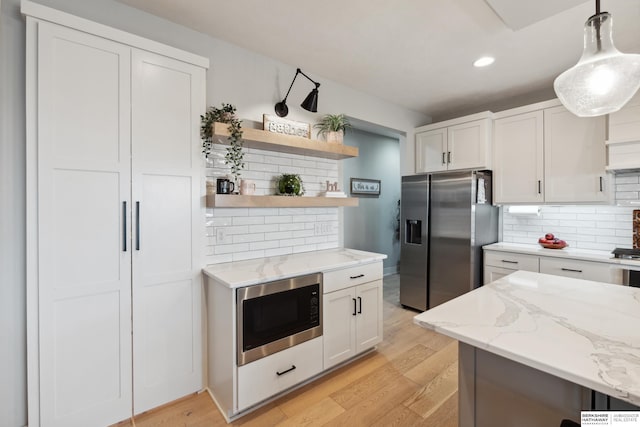 17026 Emma St, Bennington, NE 68007 - kitchen with open shelves, stainless steel refrigerator with ice dispenser, built in microwave, white cabinets, and tasteful backsplash