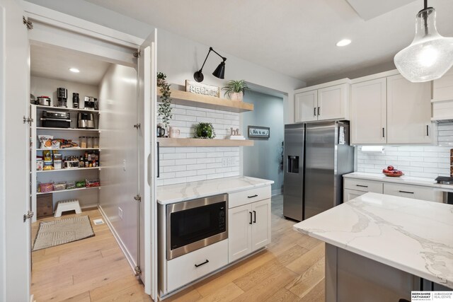 17026 Emma St, Bennington, NE 68007 - kitchen with white cabinets, open shelves, built in microwave, and stainless steel fridge with ice dispenser