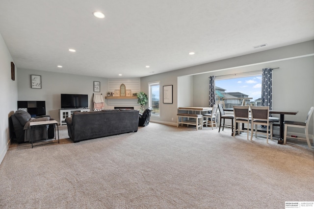 17026 Emma St, Bennington, NE 68007 - carpeted living area with recessed lighting, baseboards, visible vents, and a fireplace