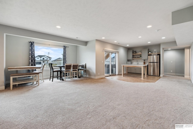 17026 Emma St, Bennington, NE 68007 - living area featuring recessed lighting, baseboards, and light colored carpet