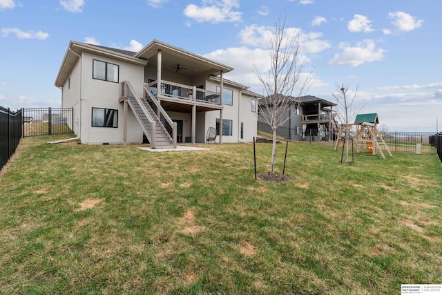 17026 Emma St, Bennington, NE 68007 - back of house with a deck, a fenced backyard, stairs, a playground, and a lawn