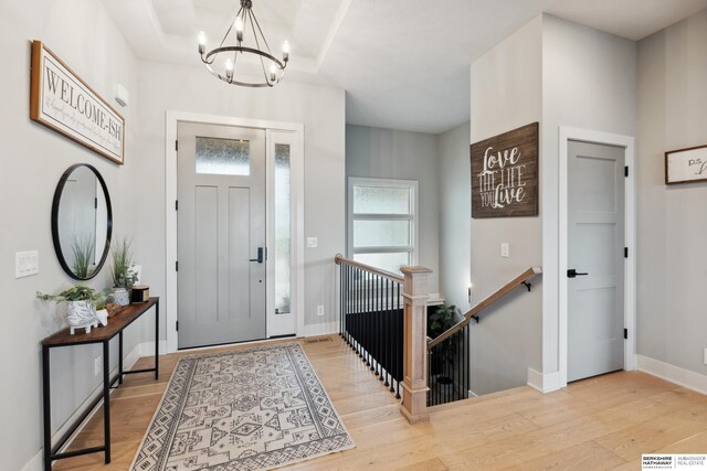 17026 Emma St, Bennington, NE 68007 - entryway with an inviting chandelier, baseboards, and wood finished floors