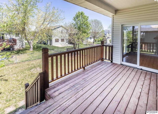 deck with a lawn and a residential view