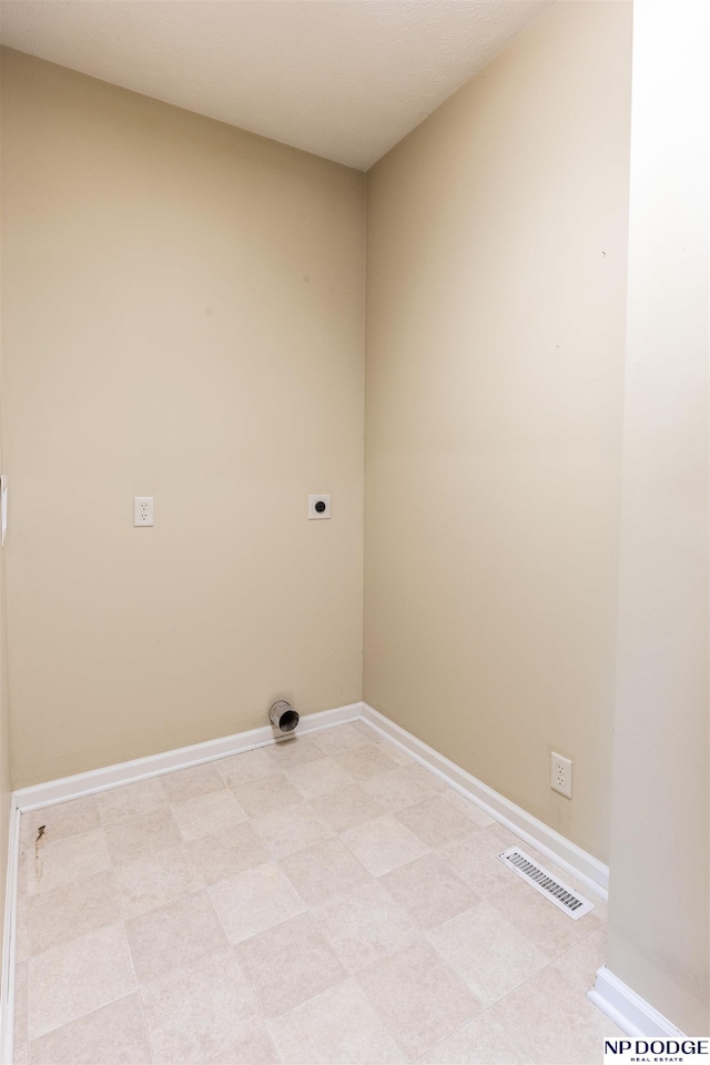 clothes washing area with baseboards, laundry area, electric dryer hookup, and visible vents