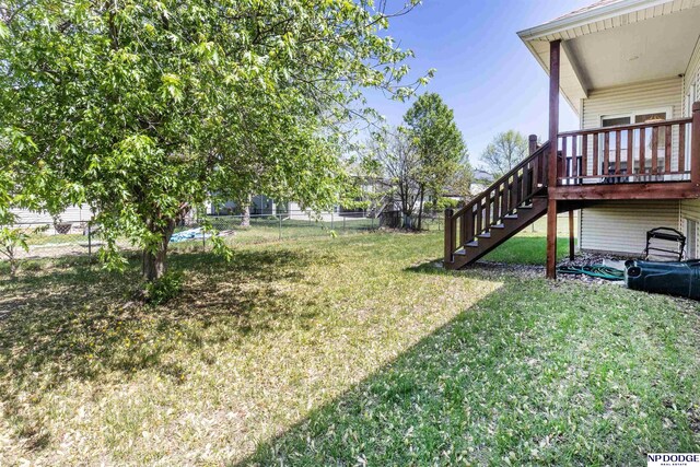 view of yard featuring a fenced backyard and stairway
