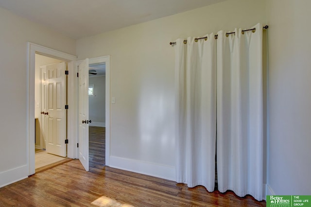 unfurnished room featuring wood finished floors and baseboards