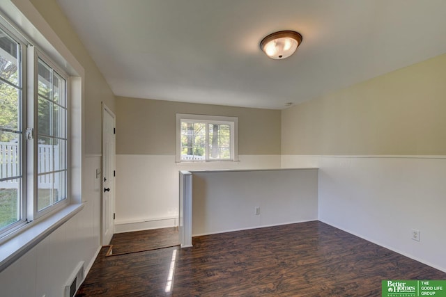 unfurnished room with visible vents and wood finished floors