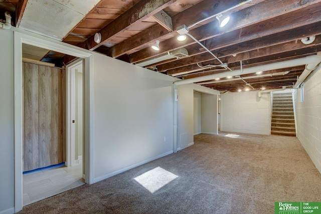 finished basement with carpet and stairs