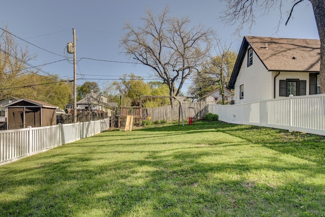 view of yard featuring a playground and a fenced backyard