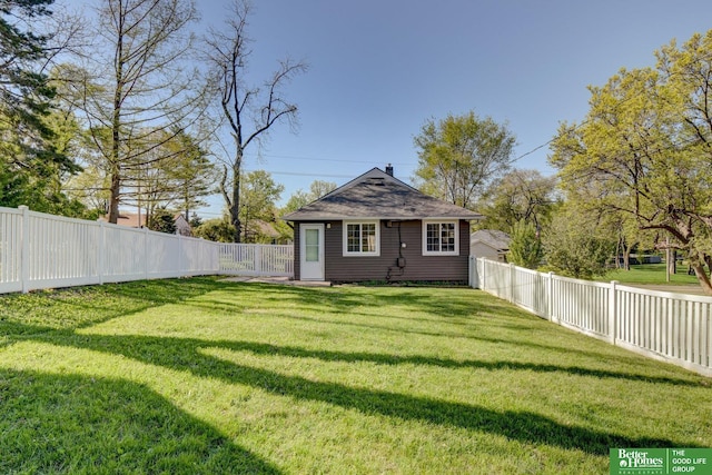 view of yard with an outdoor structure and a fenced backyard