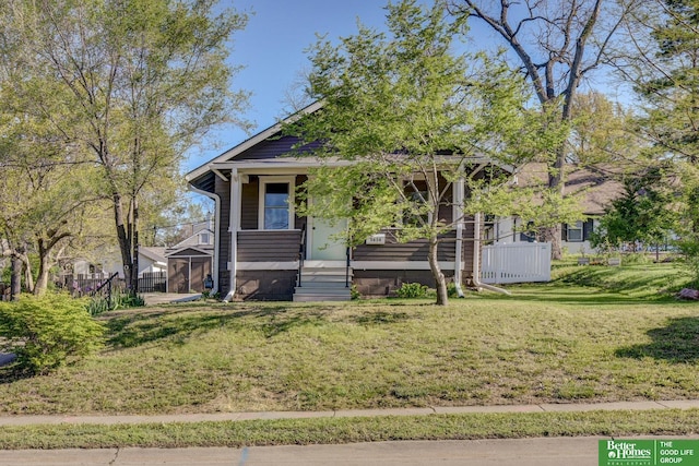 view of front of home with a front yard and covered porch