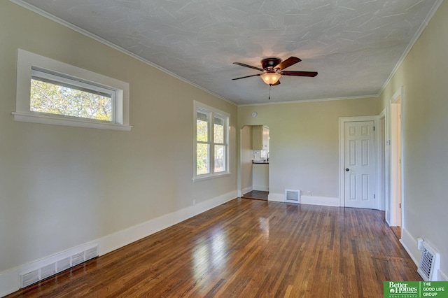 unfurnished room with a ceiling fan, visible vents, and wood finished floors