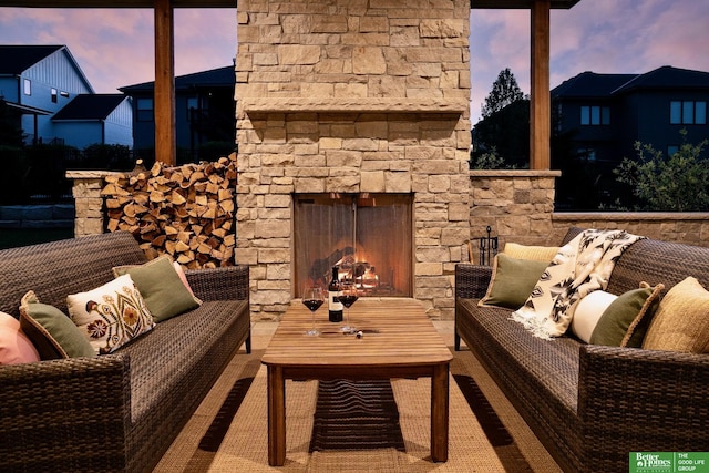 balcony with a patio and an outdoor living space with a fireplace