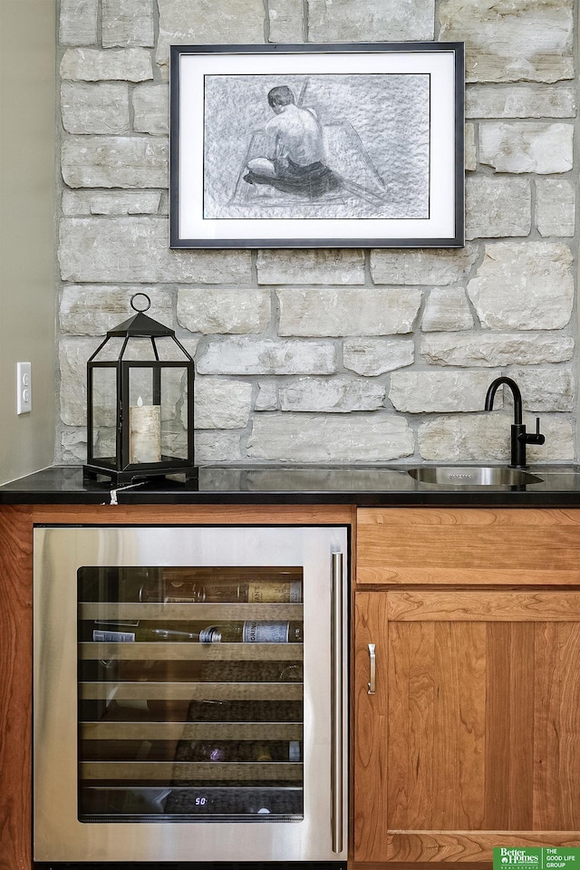 bar featuring beverage cooler and a sink