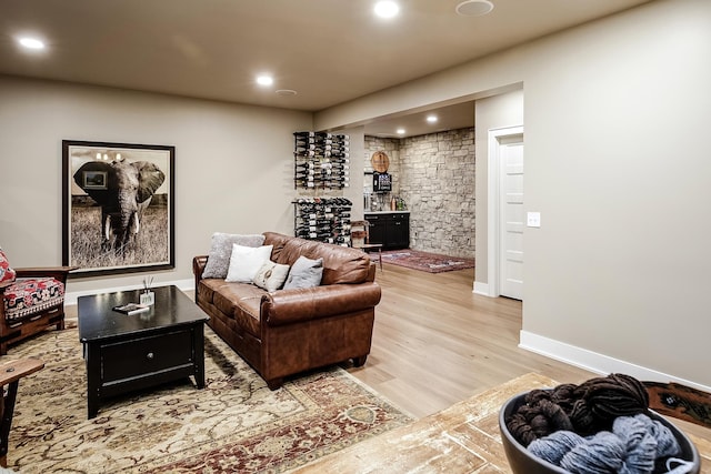 living area featuring recessed lighting, baseboards, and light wood-type flooring