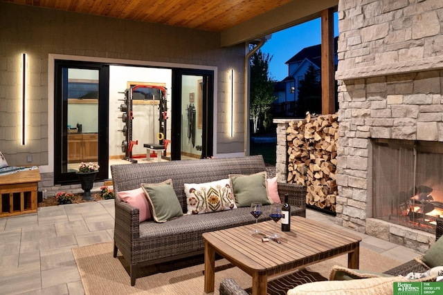 view of patio with an outdoor living space with a fireplace