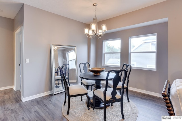 dining area with baseboards, an inviting chandelier, and dark wood-style floors