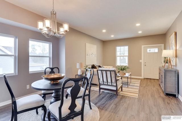 dining room featuring recessed lighting, baseboards, plenty of natural light, and light wood-style flooring