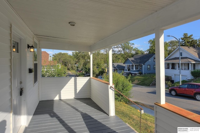 wooden deck featuring a residential view