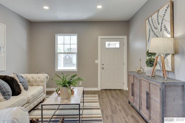 living area featuring recessed lighting, light wood finished floors, and baseboards
