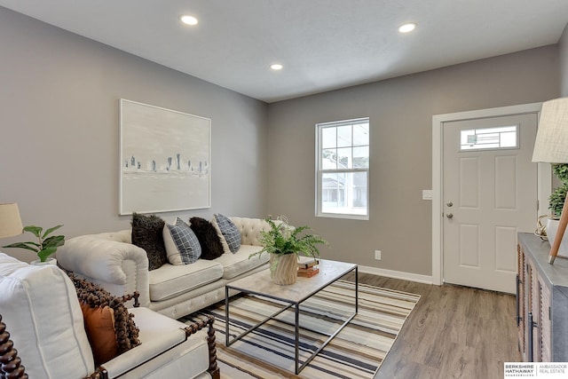 living room featuring recessed lighting, light wood finished floors, and baseboards