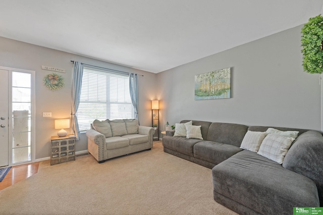 carpeted living room featuring baseboards
