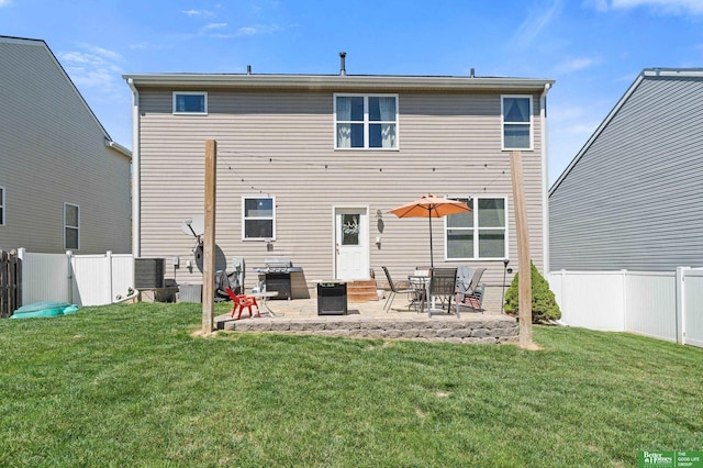 rear view of property with a fenced backyard, a patio, entry steps, and a yard