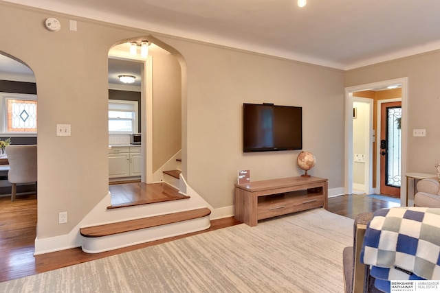 5117 Western Ave, Omaha, NE 68132 - living area featuring arched walkways, wood finished floors, stairs, and baseboards