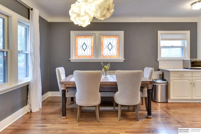 5117 Western Ave, Omaha, NE 68132 - dining area with a chandelier, light wood-style floors, and plenty of natural light