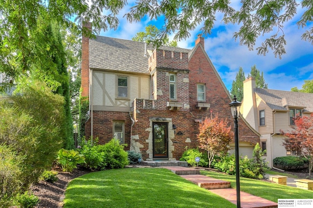5117 Western Ave, Omaha, NE 68132 - tudor-style house with brick siding, a front lawn, a chimney, and stucco siding