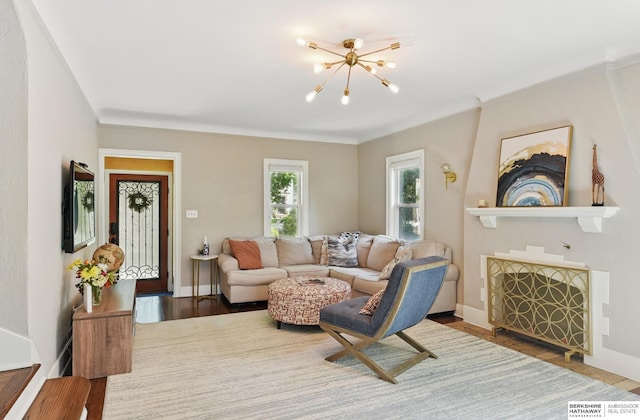 5117 Western Ave, Omaha, NE 68132 - living area featuring a chandelier, wood finished floors, baseboards, and ornamental molding