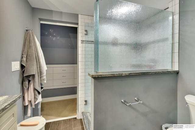 5117 Western Ave, Omaha, NE 68132 - bathroom with toilet, wood finished floors, and tiled shower